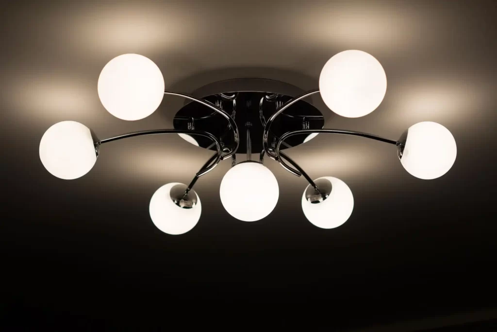 Modern black pendant light fixture hanging from ceiling in living room