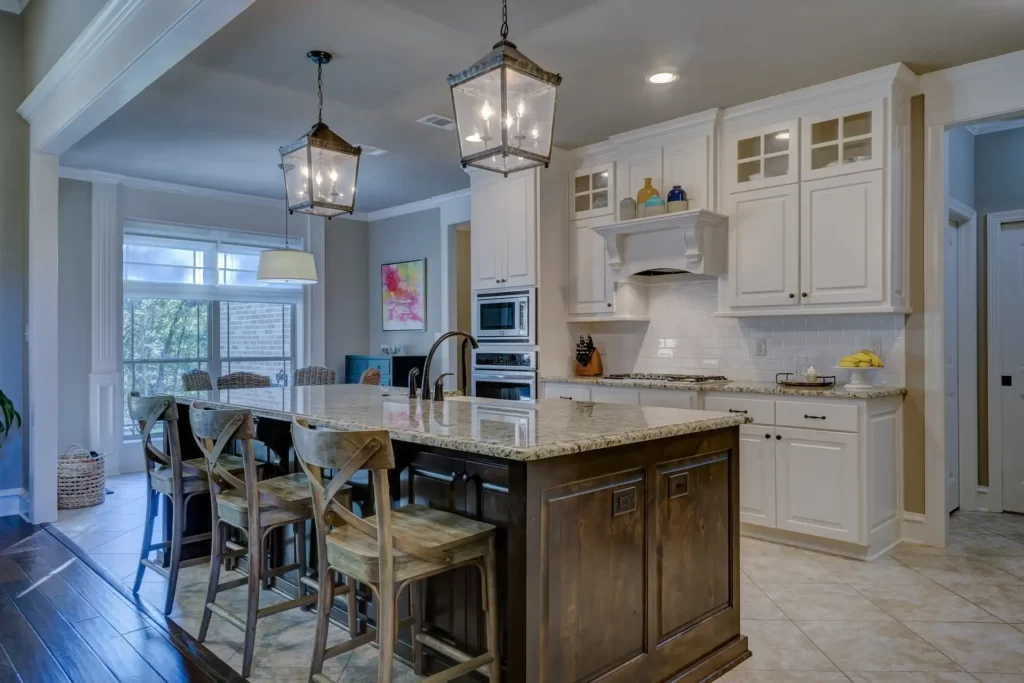 Kitchen light fixture hanging from the ceiling illuminating the room with warm white light.